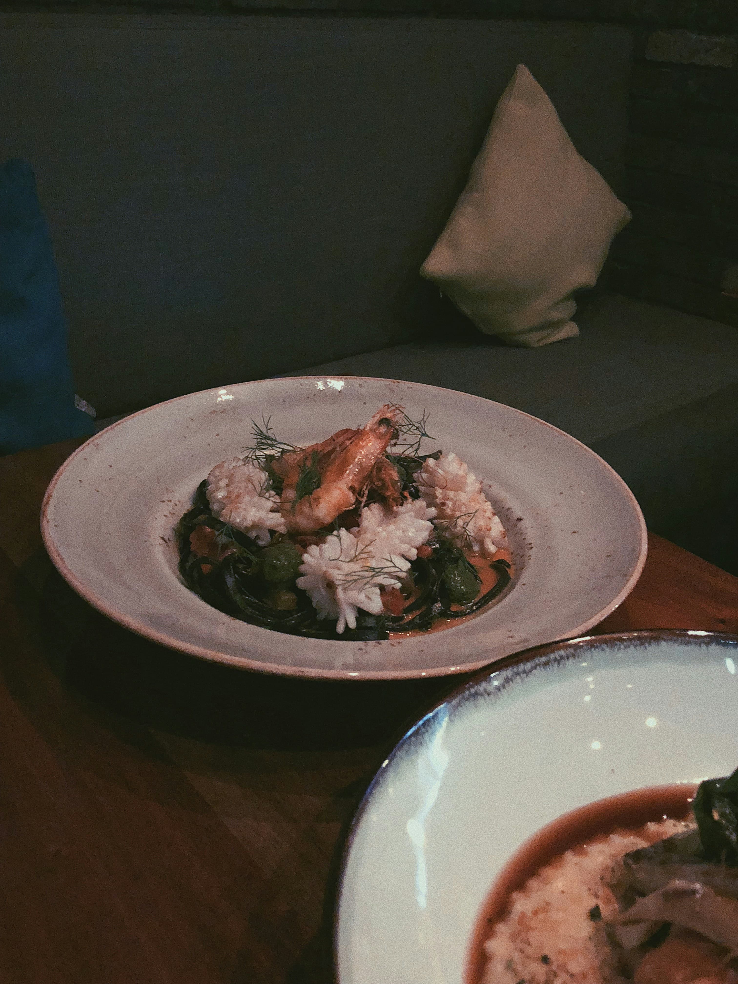 Fine-dining fish course on a textured plate