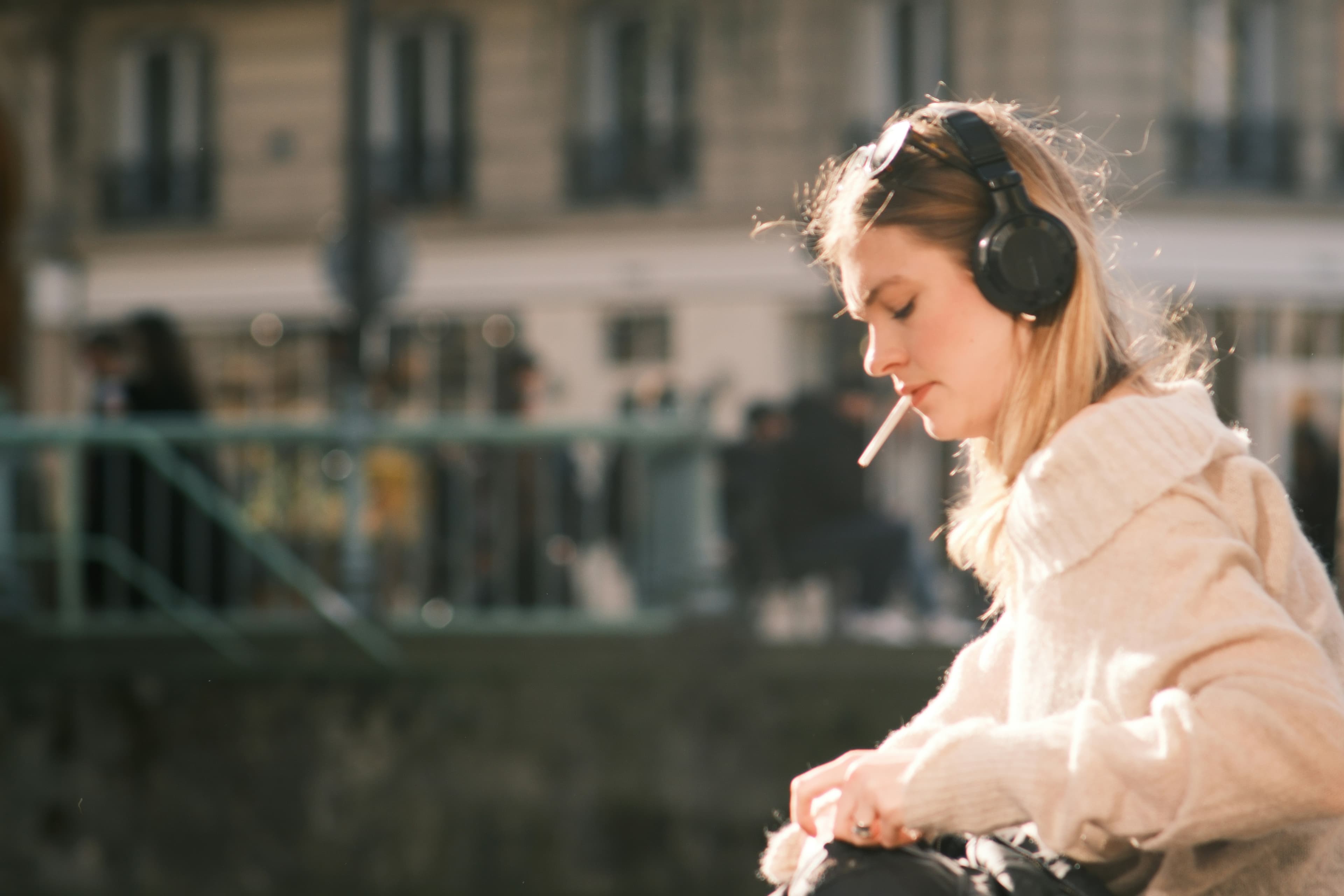 Streamer wearing headphones, lit by green and magenta room lighting