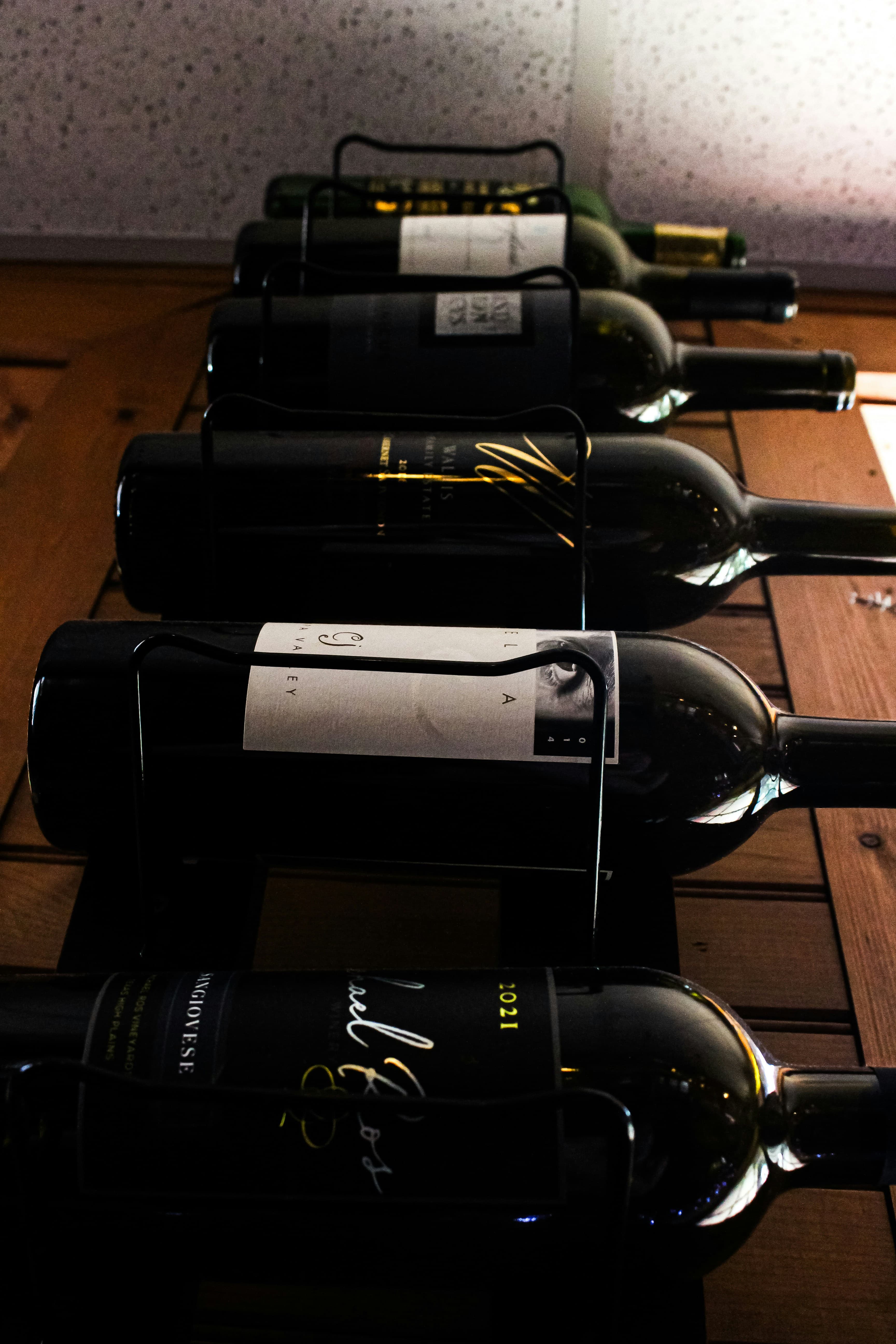 Wine bottles arranged on a cellar rack